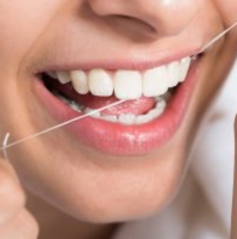 what comes first floss or brushing teeth