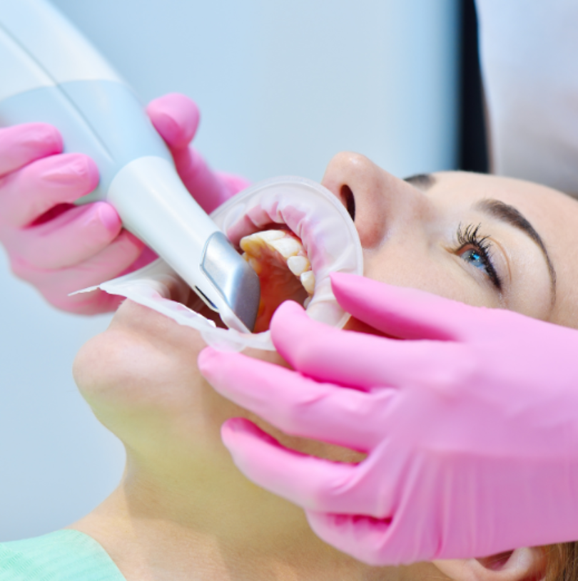 dentist using air abrasion tool on patient i.e.